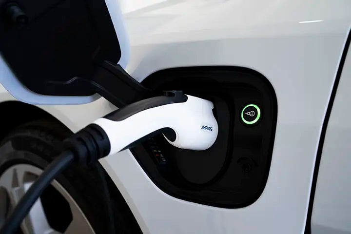 Electric vehicle charging cable plugged into a car's charging port.