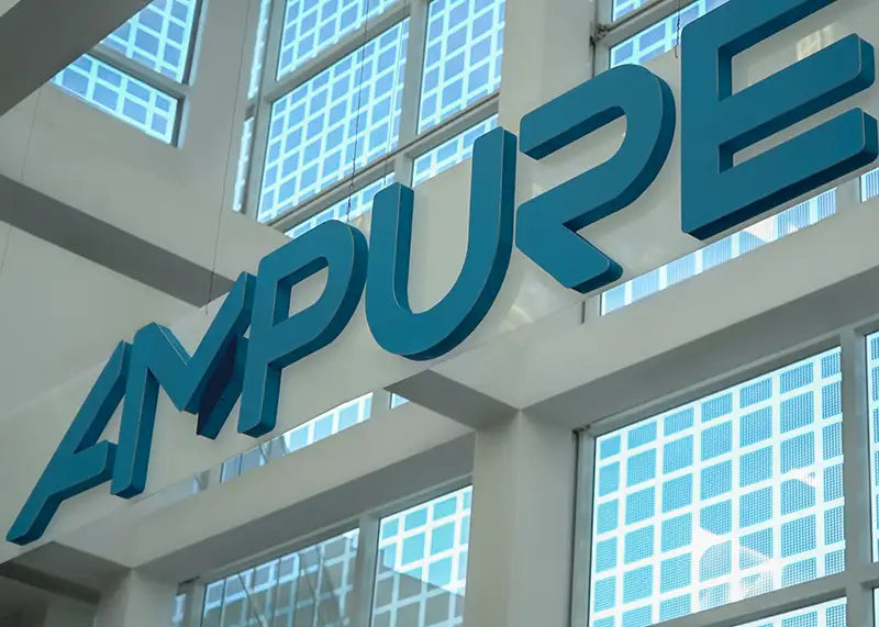 AMPURE logo on a building facade with large windows