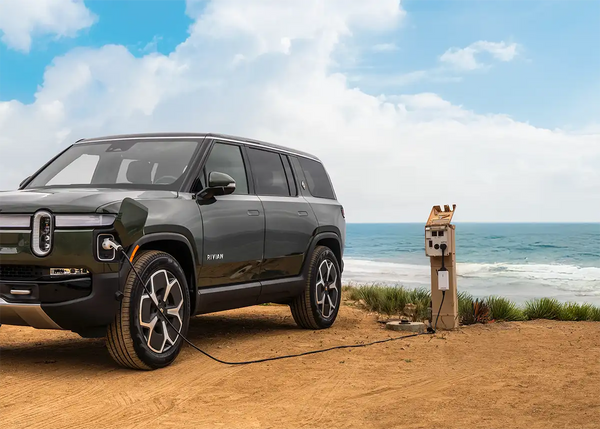 Electric vehicle charging station by the ocean with a car plugged in
