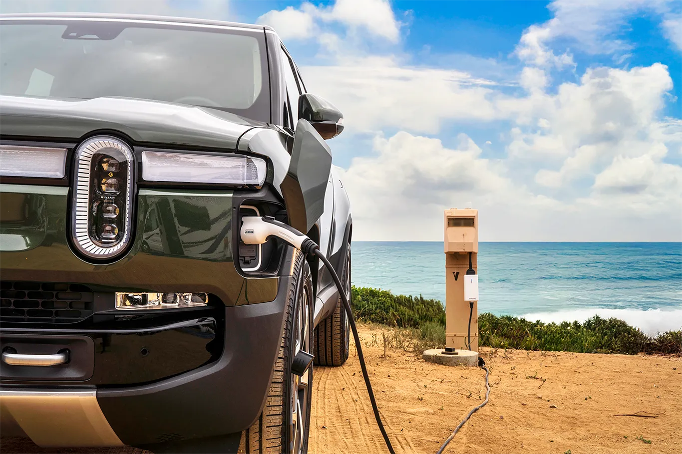 Electric vehicle charging with a scenic ocean view in the background