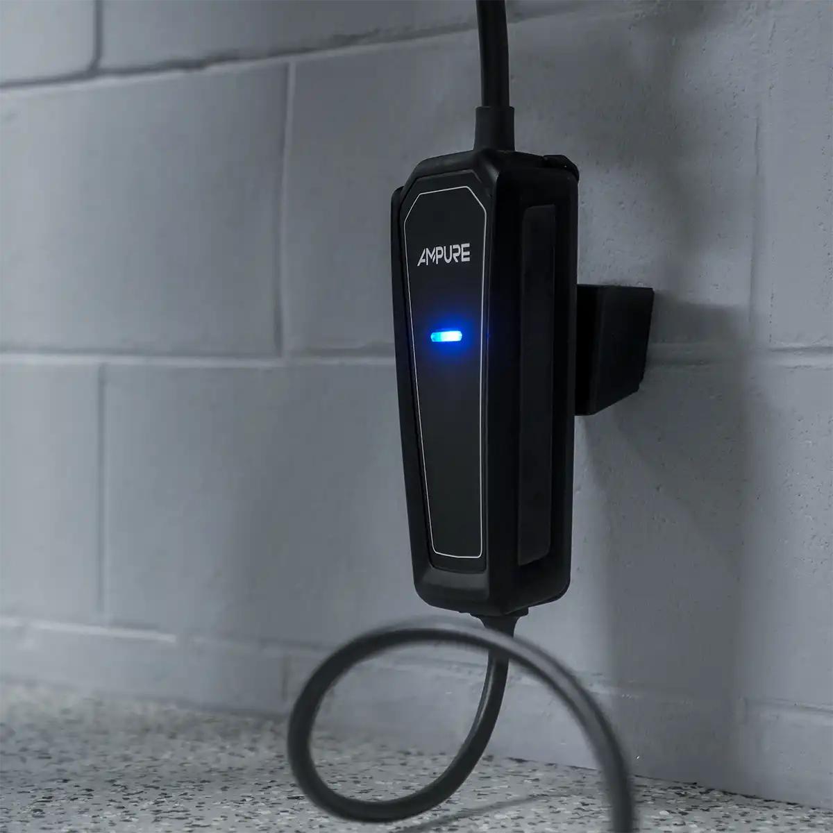 Black electronic device with blue light on a tiled wall background